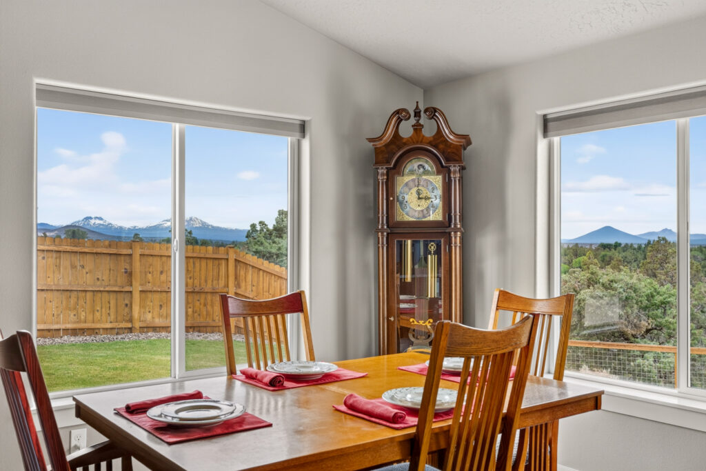 Dining room with large windows framing snow-capped Cascade mountain views near Bend, Oregon